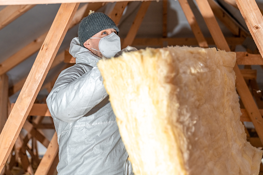 man insulating attic