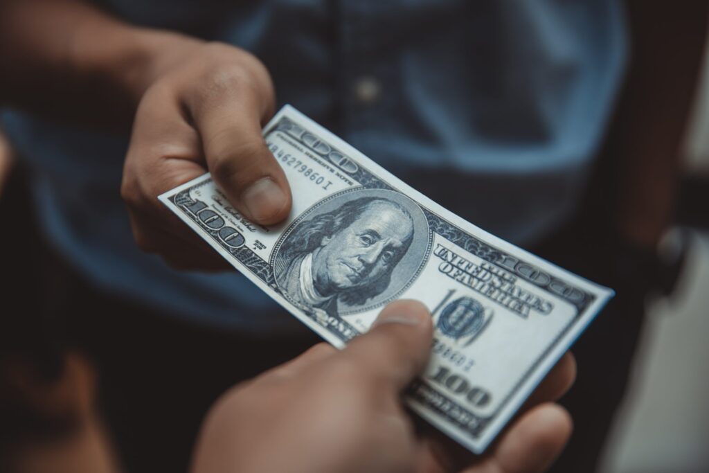 person paying for window and gutter cleaning