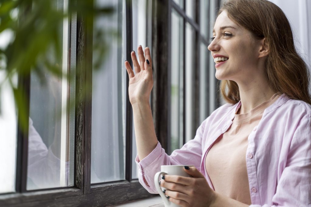 Woman smiling near window