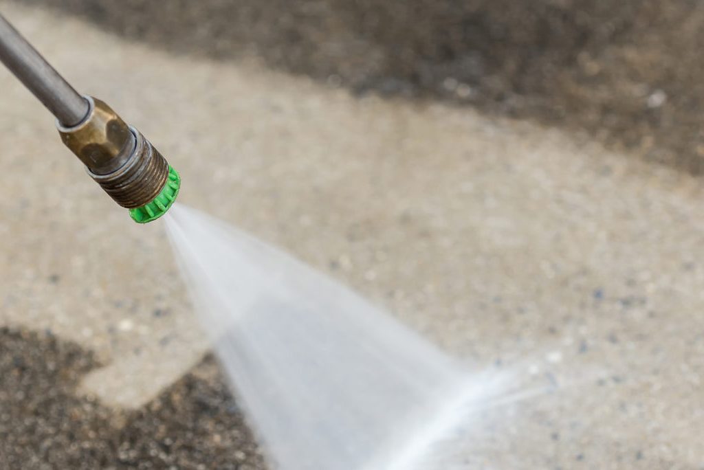power washing concrete driveway close up