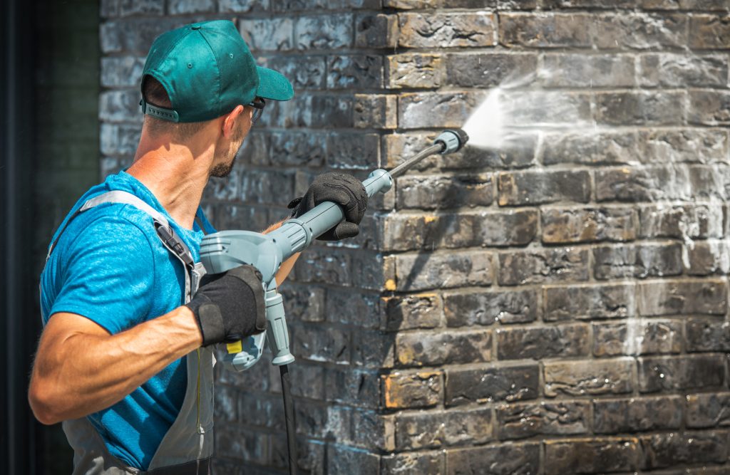 brick pressure washing a house