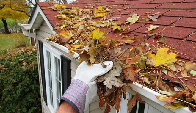 hand cleaning gutters