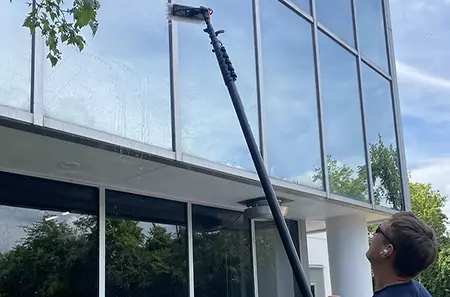 commercial window cleaner using the water-fed pole