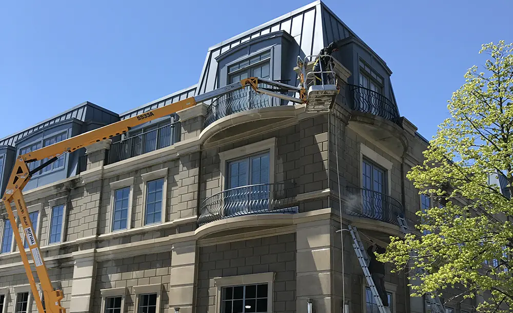 office building window washing with boom lift