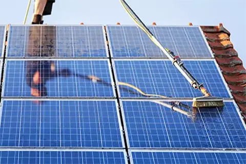 man cleaning solar panels