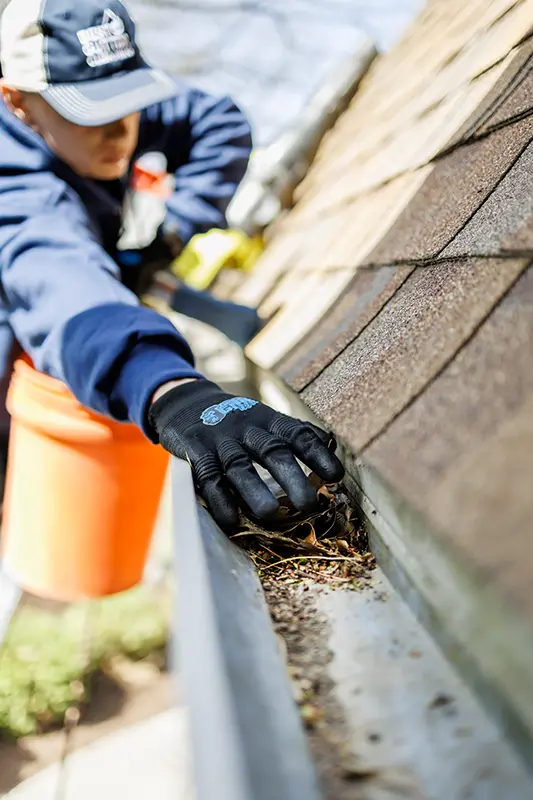 Gutter cleaner on a ladder at a Chicago-area home