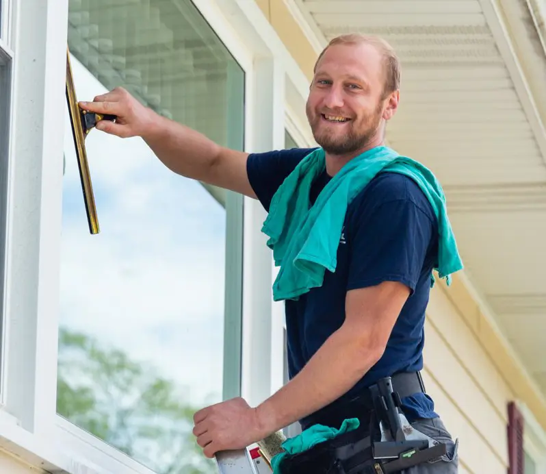 Technician cleaning a window