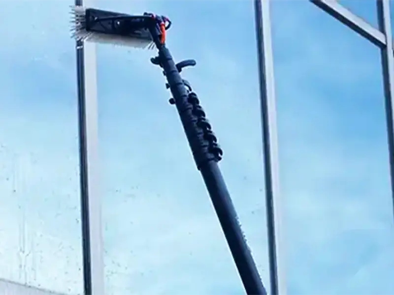 Water-fed pole cleaning upper office windows at a Chicagoland commercial building