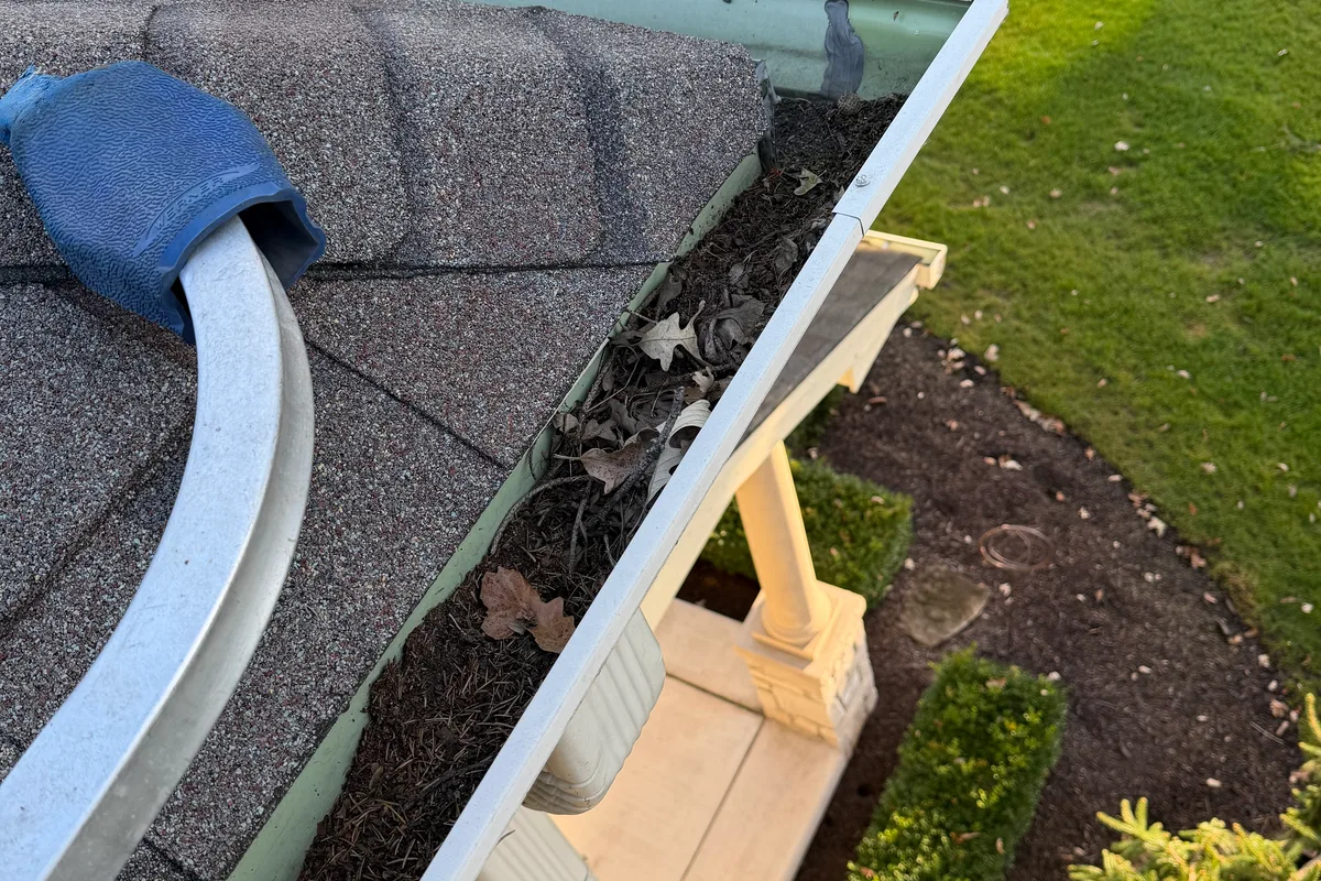 Gutter Cleaning before — Twin Lakes IL 2-story house