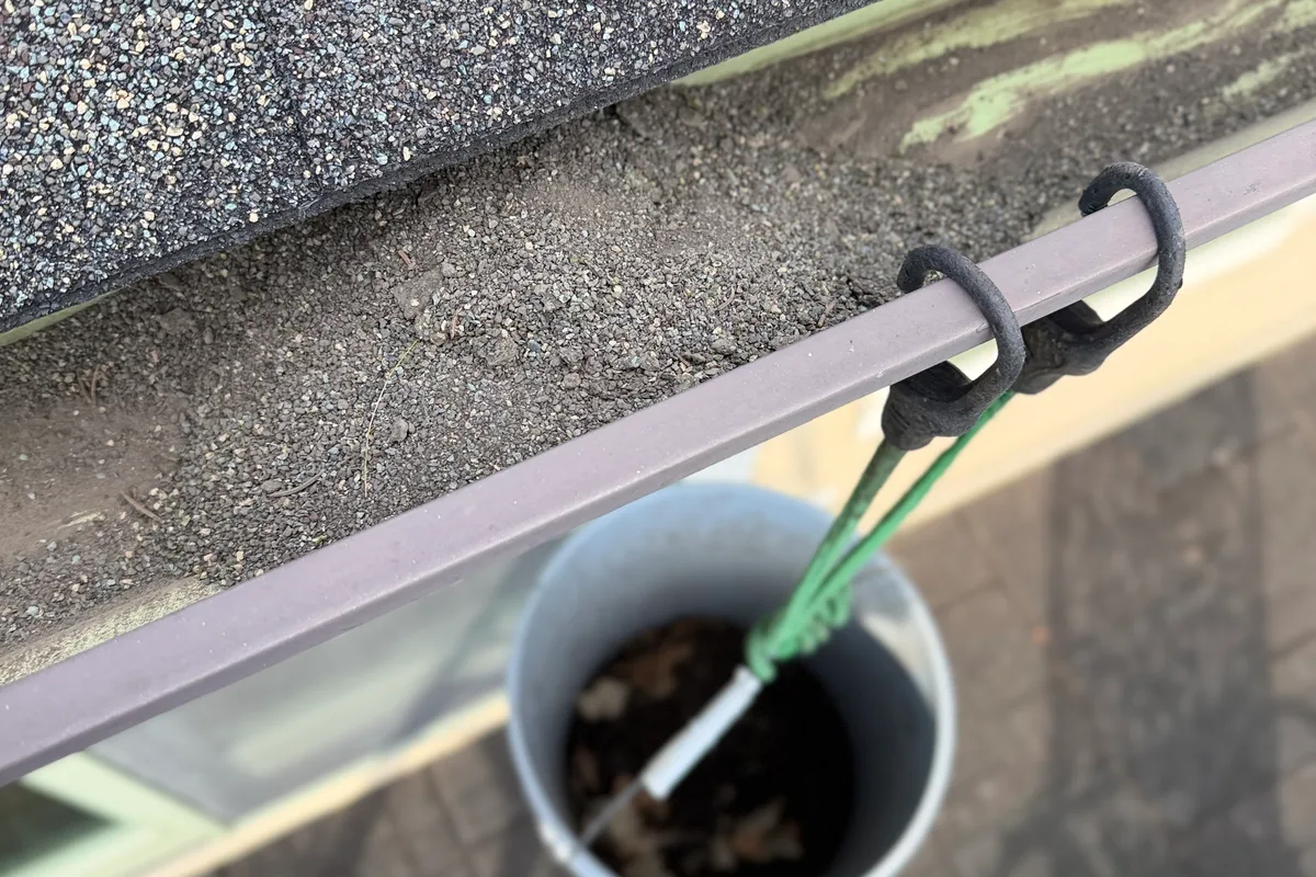Gutter Cleaning before — Twin Lakes IL 2-story house
